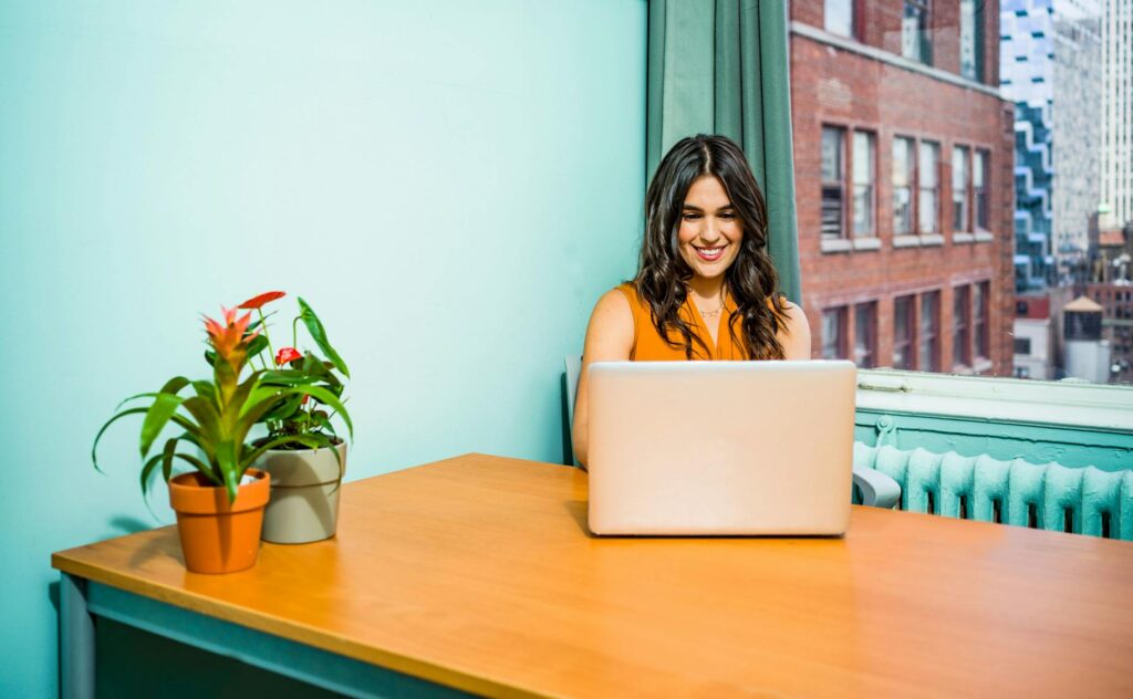 Small business owner on her laptop learning how to get recommended on ChatGPT